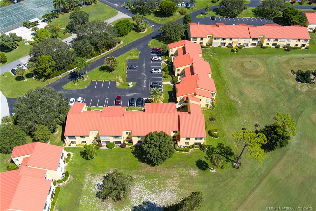 5313 Southeast Miles Grant Road, Unit K209 Stuart, FL 34997 - Photo 32 of 34 an aerial view of a house with a yard and lake view