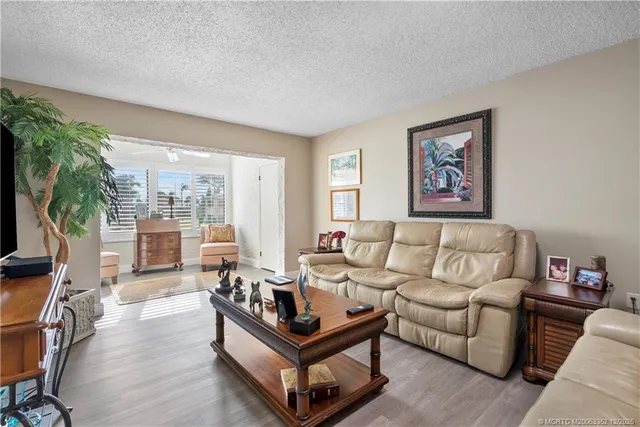 a spacious bedroom with a bed and a flat screen tv