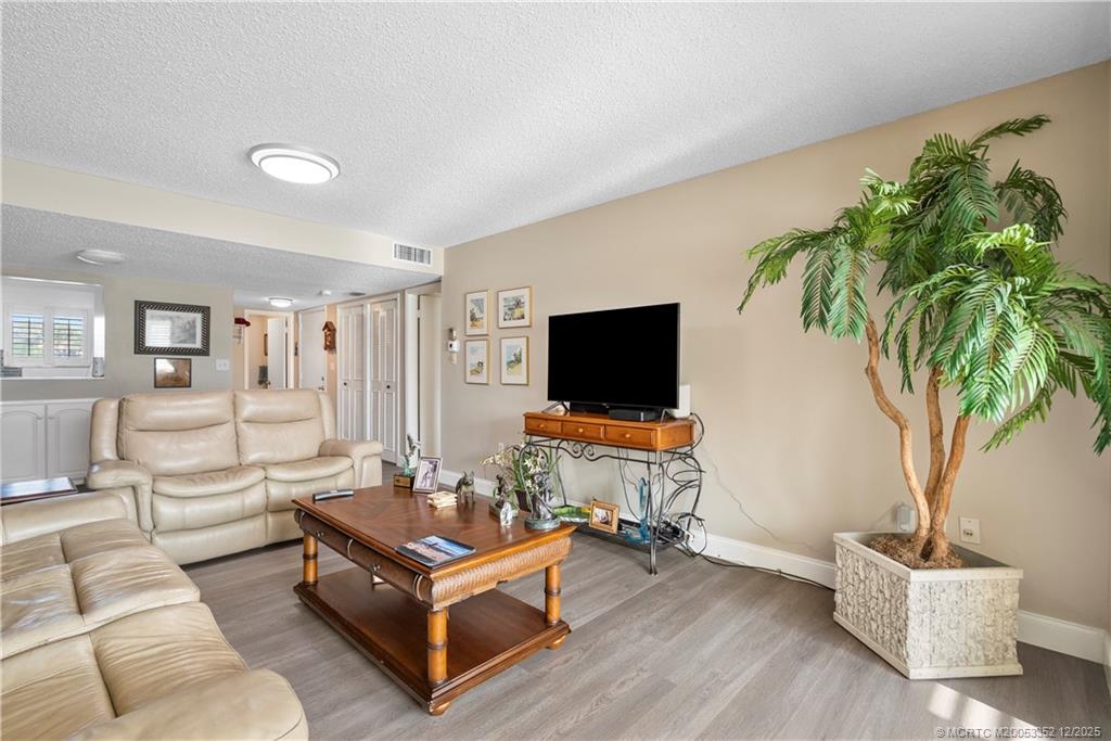 5313 Southeast Miles Grant Road, Unit K209 Stuart, FL 34997 - Photo 7 of 34 a living room with furniture and a flat screen tv