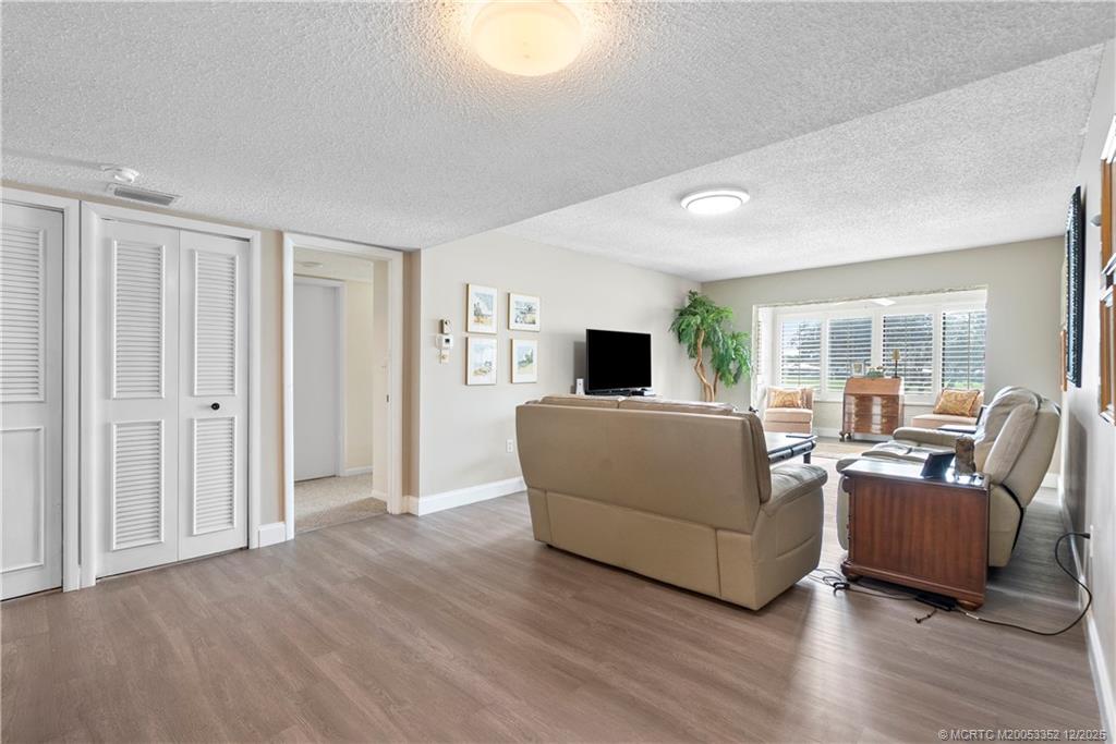 5313 Southeast Miles Grant Road, Unit K209 Stuart, FL 34997 - Photo 8 of 34 a living room with furniture and a flat screen tv