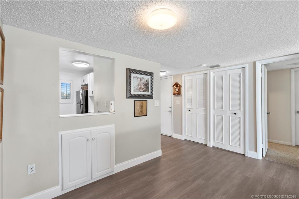 5313 Southeast Miles Grant Road, Unit K209 Stuart, FL 34997 - Photo 10 of 34 a view of a big room with wooden floor and windows