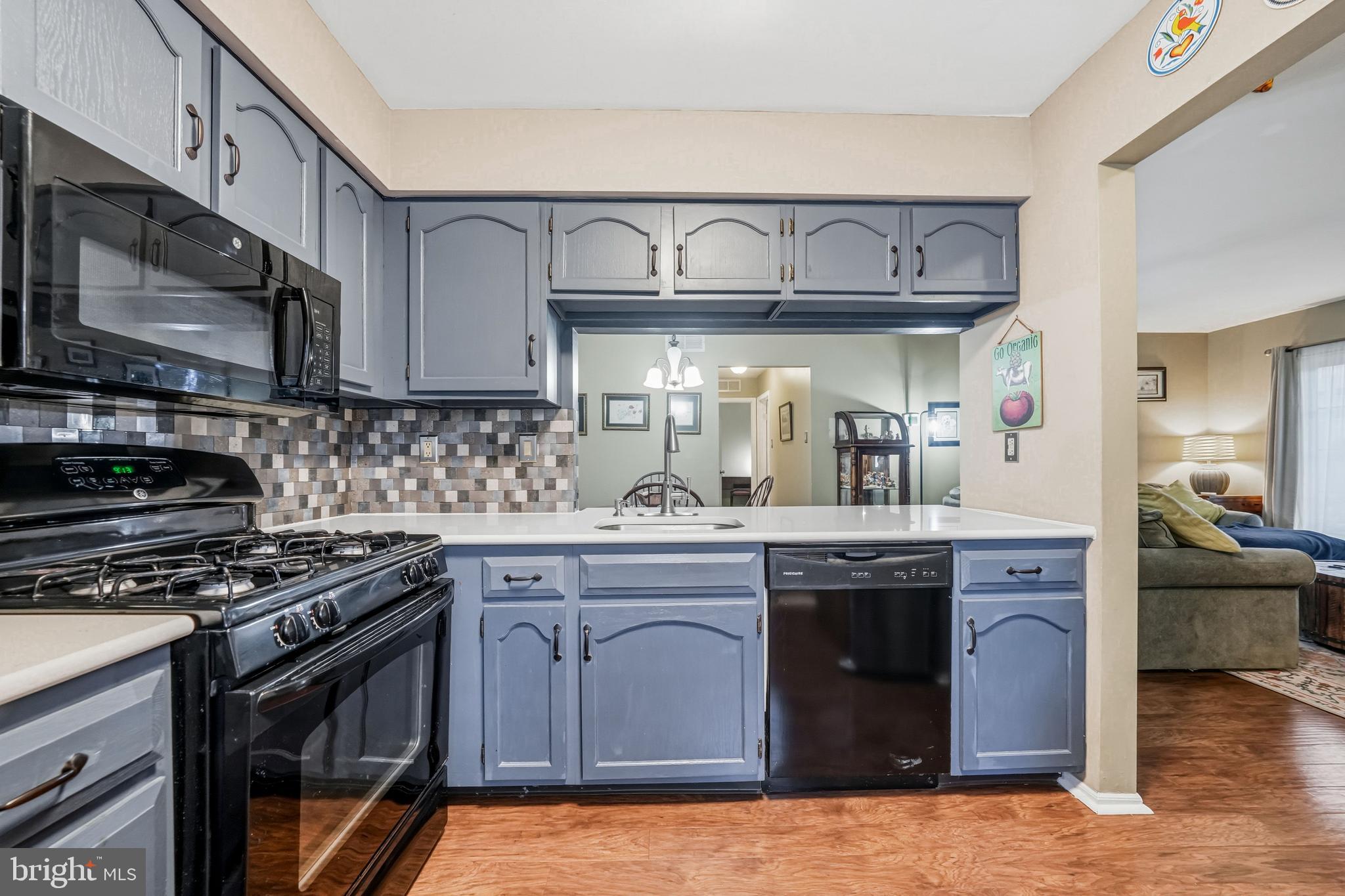 3305A Ramsbury Court Mount Laurel, NJ 08054 - Photo 15 of 27 a kitchen with stainless steel appliances granite countertop a stove and a microwave