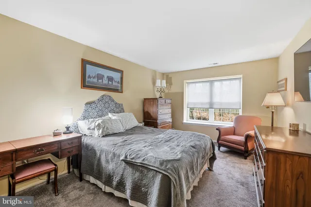 a bedroom with a bed and a couch