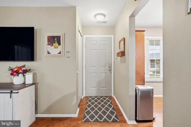 a hallway with table and mirror