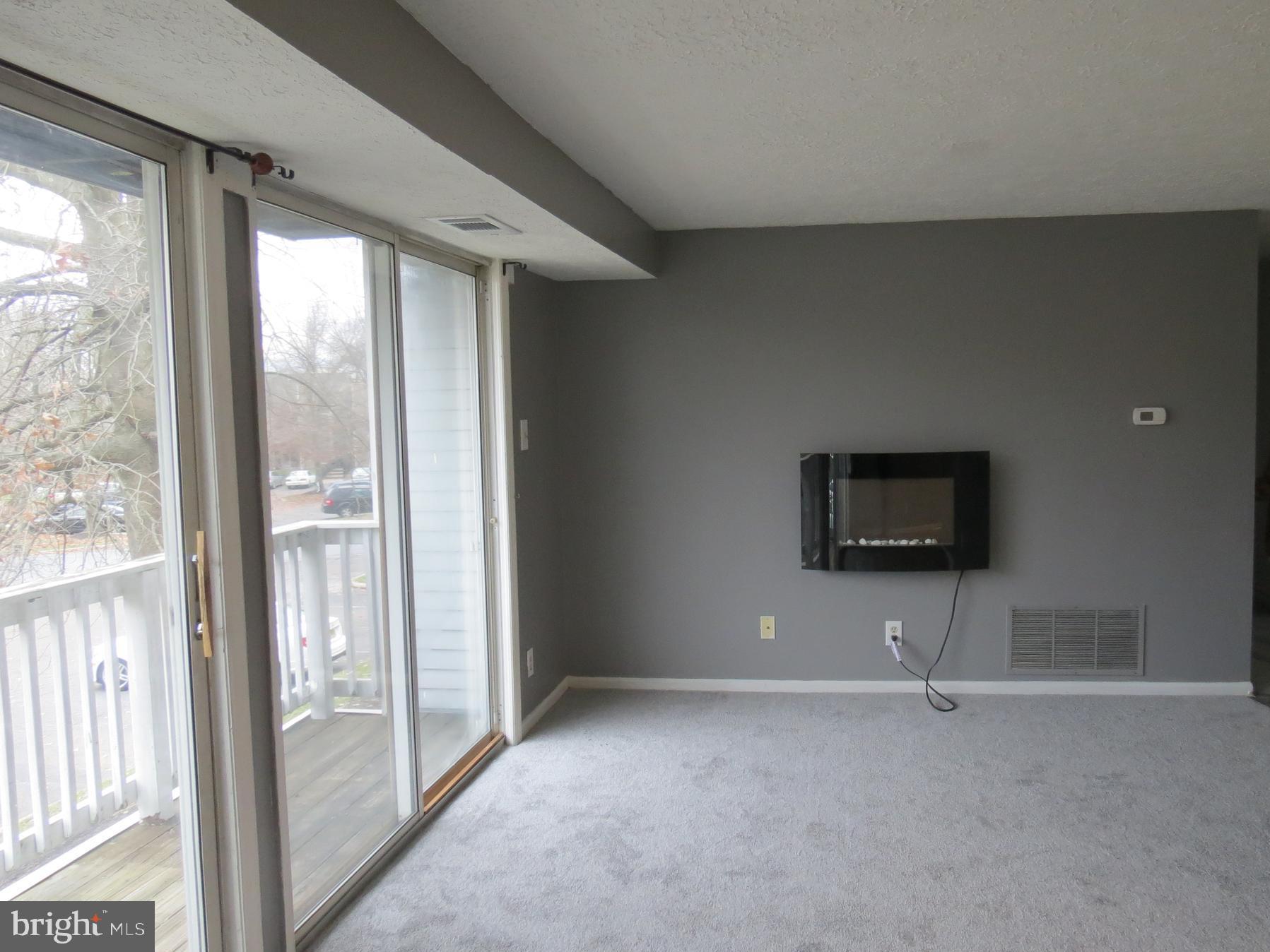 153 Kenwood Drive Sicklerville, NJ 08081 - Photo 3 of 13 a view of a livingroom with an empty space and a window