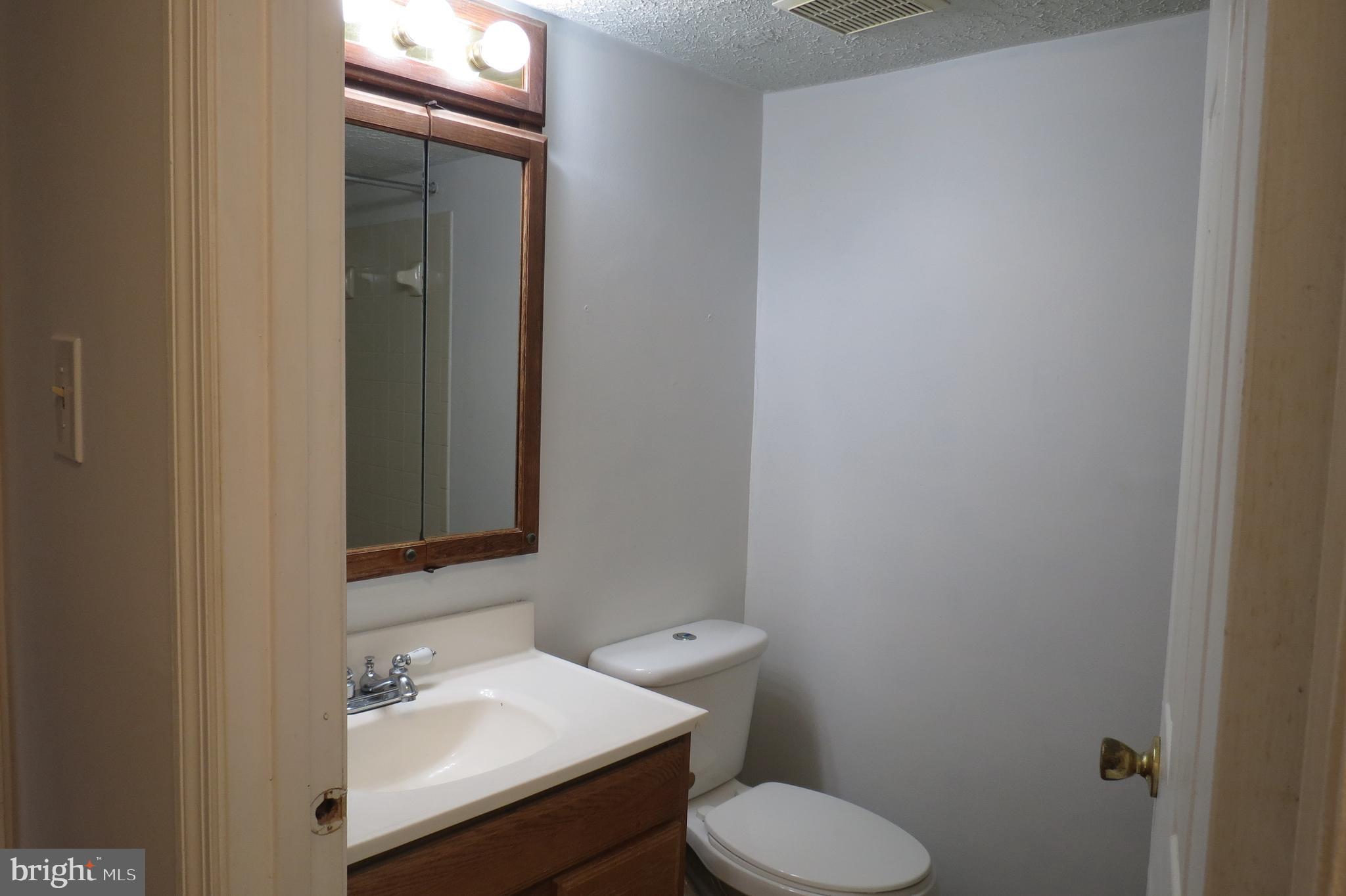 153 Kenwood Drive Sicklerville, NJ 08081 - Photo 9 of 13 a bathroom with a sink toilet and mirror