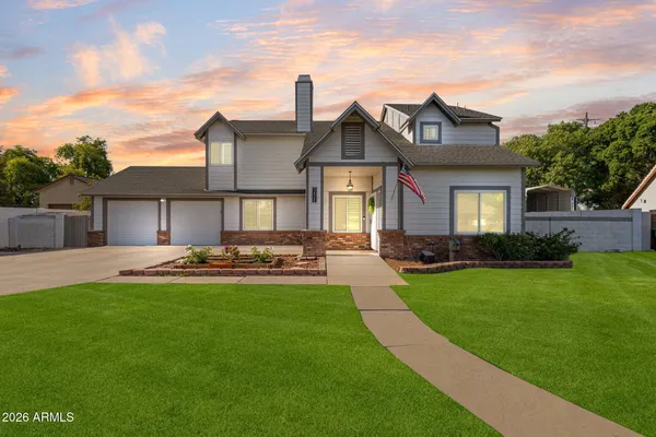 a front view of a house with a garden and plants