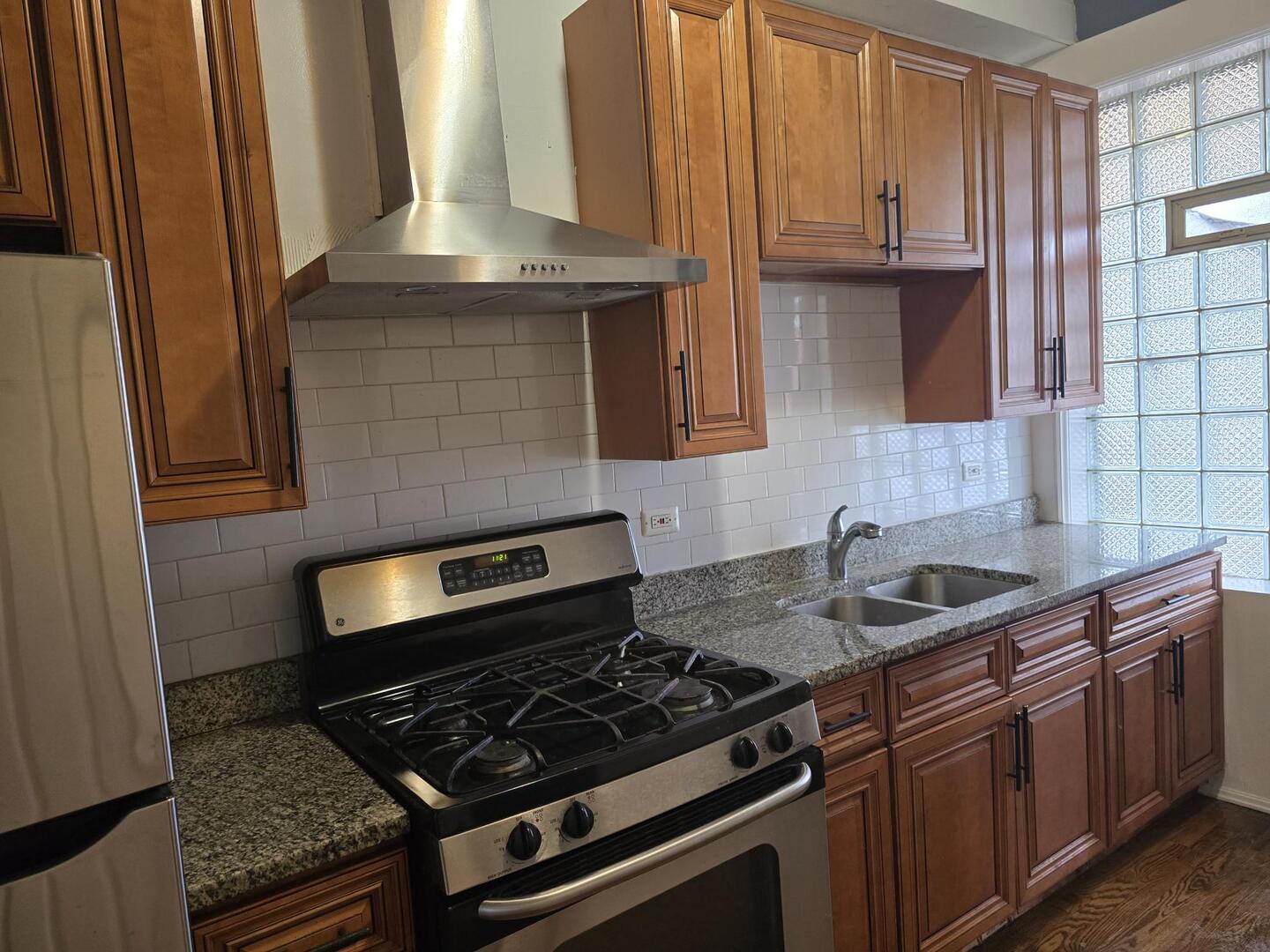 7317 South Union Avenue Chicago, IL 60621 - Photo 7 of 26 a kitchen with granite countertop a sink stove and cabinets