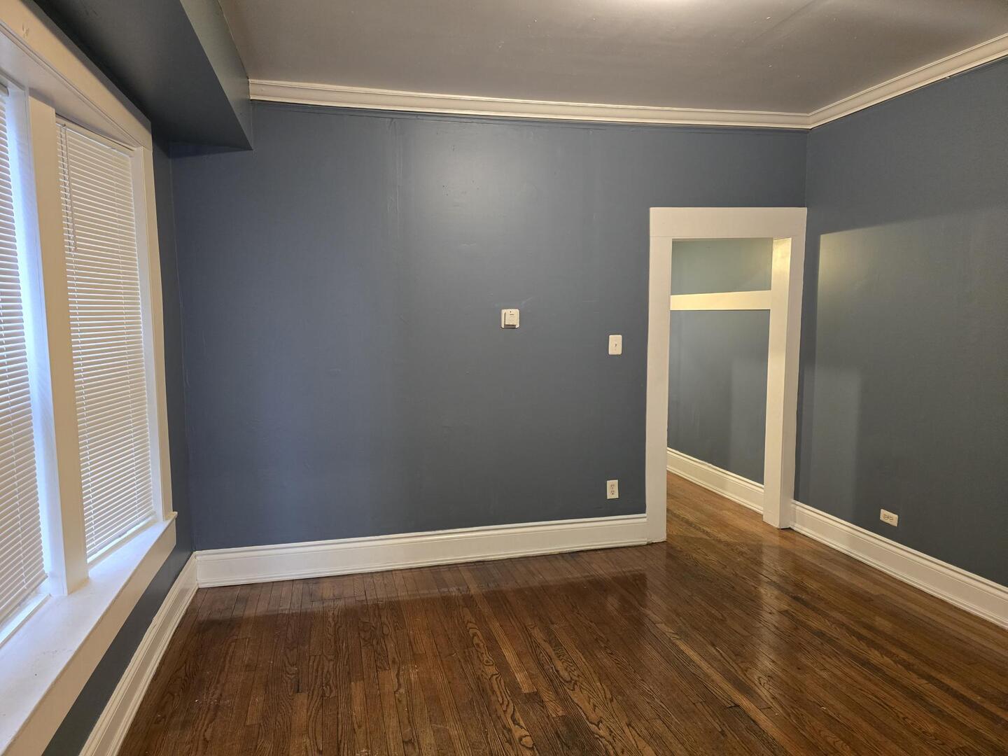 7317 South Union Avenue Chicago, IL 60621 - Photo 8 of 26 a view of an empty room with wooden floor and a window