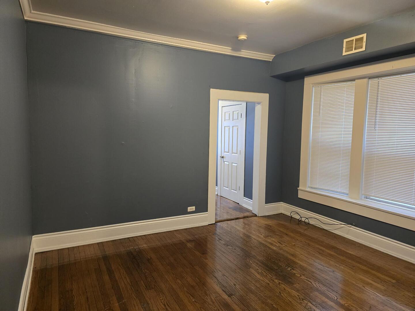 7317 South Union Avenue Chicago, IL 60621 - Photo 9 of 26 a view of an empty room with wooden floor