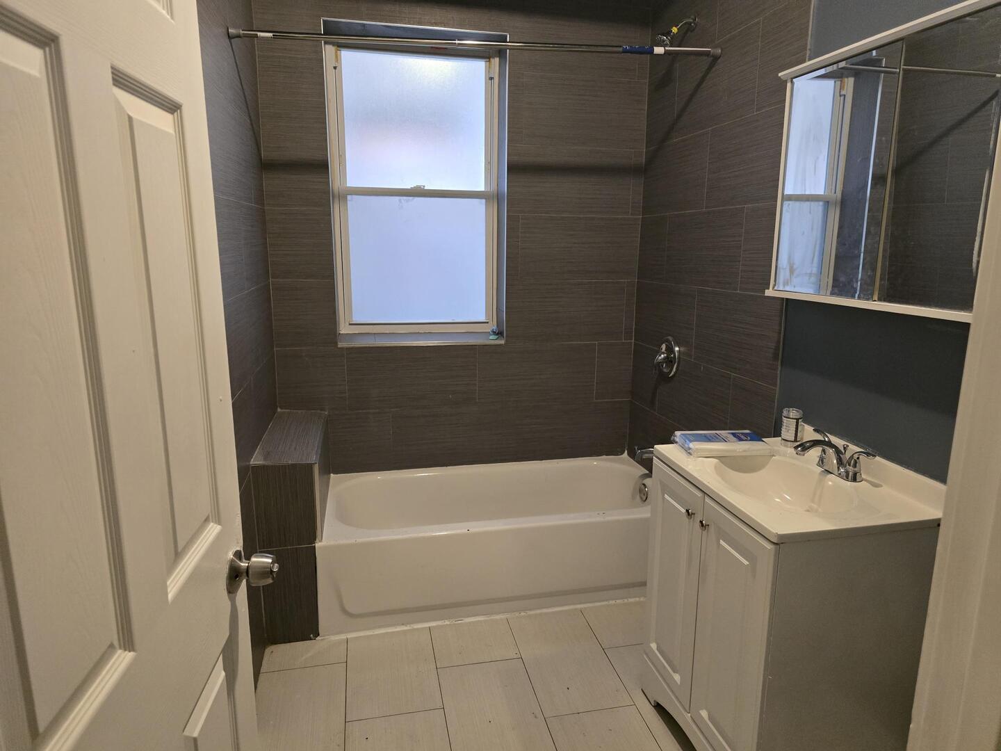 7317 South Union Avenue Chicago, IL 60621 - Photo 10 of 26 a bathroom with a sink a bathtub and a shower