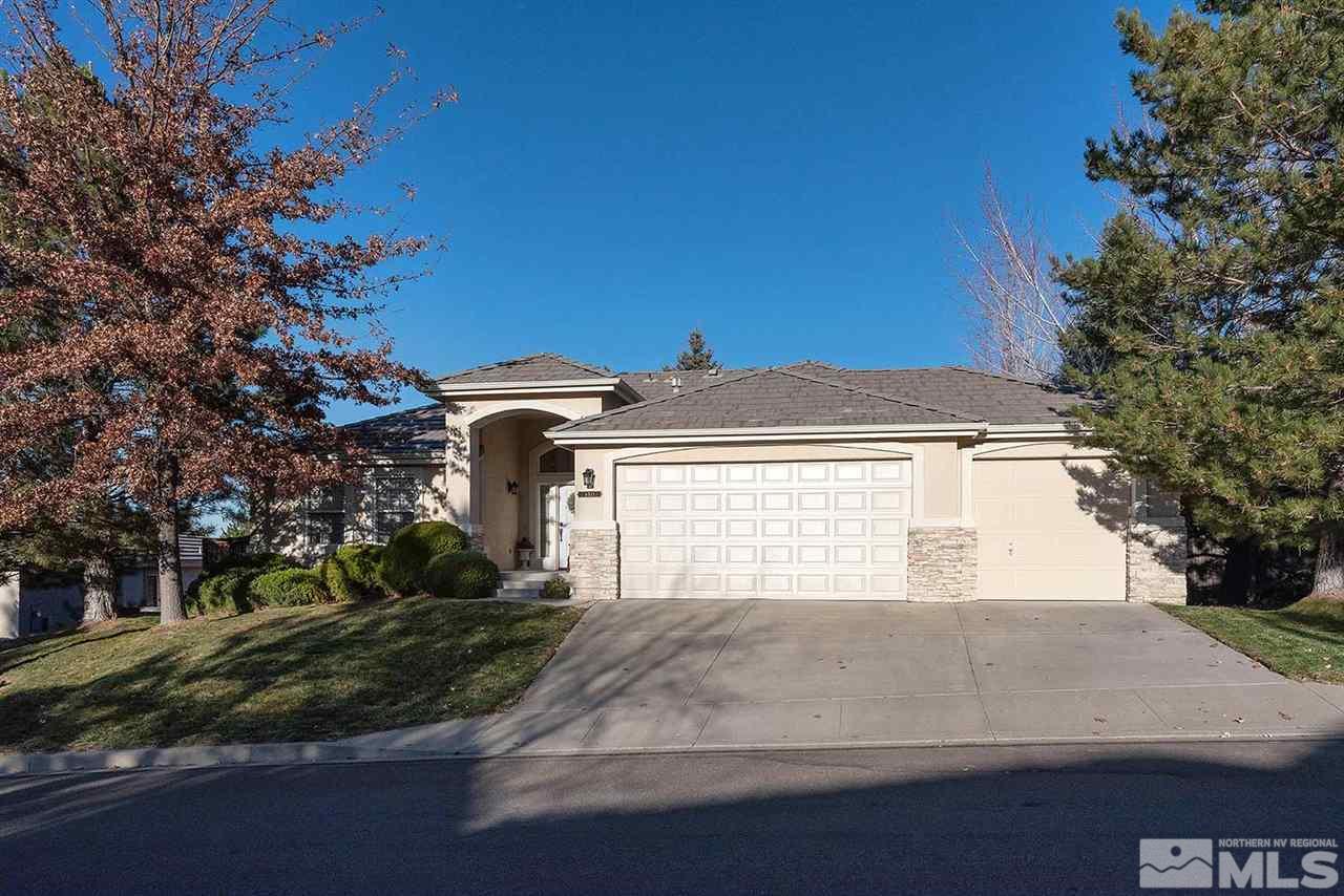 4811 East Creek Ridge Trail Reno, NV 89519 - Photo 1 of 25 a view of a house with a yard and garage