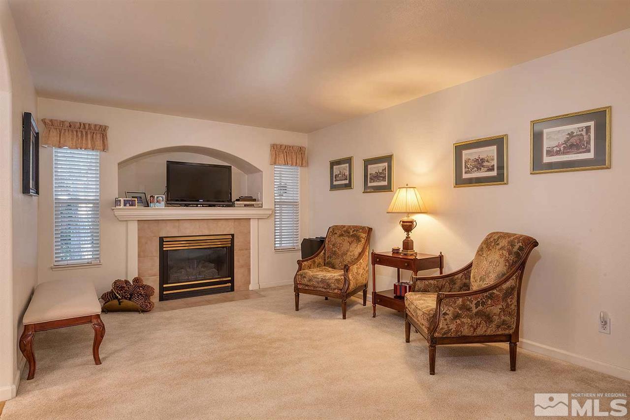 4811 East Creek Ridge Trail Reno, NV 89519 - Photo 11 of 25 a living room with furniture a flat screen tv and a fireplace