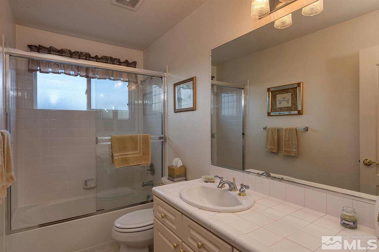 4811 East Creek Ridge Trail Reno, NV 89519 - Photo 17 of 25 a bathroom with a sink a toilet and shower