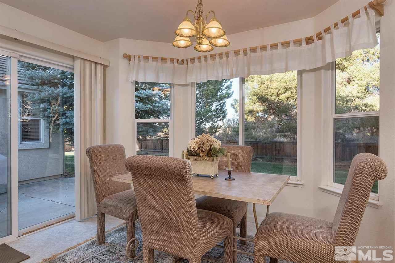 4811 East Creek Ridge Trail Reno, NV 89519 - Photo 4 of 25 a dining room with furniture a chandelier and wooden floor