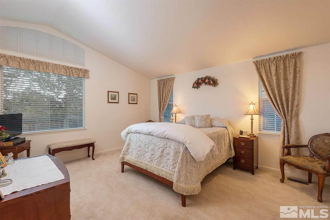 4811 East Creek Ridge Trail Reno, NV 89519 - Photo 7 of 25 a bedroom with a bed and a couch