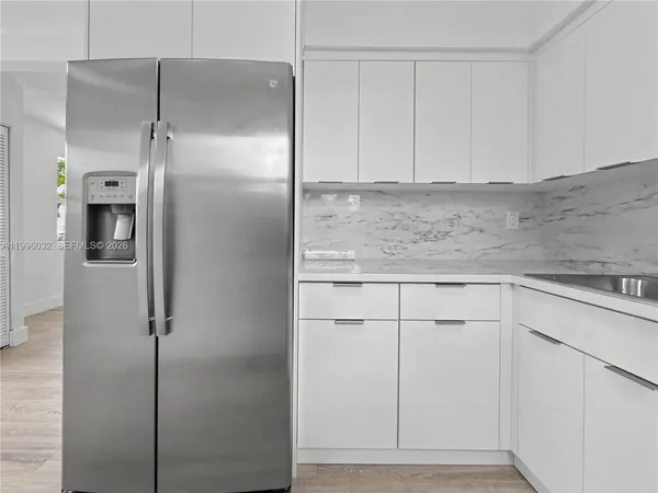 a kitchen with cabinets and stainless steel appliances