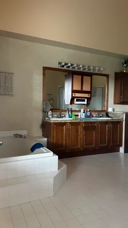 a kitchen with kitchen island granite countertop a sink and a stove