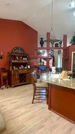 a room with furniture pool table and chairs