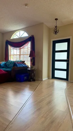 a living room with a couch and a window
