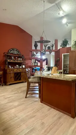 a room with lots of wooden furniture and a chandelier