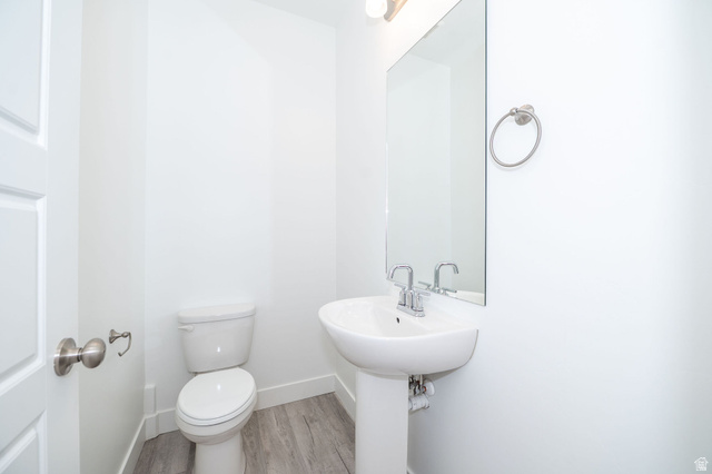 46 West 460 Smithfield, UT 84335 - Photo 13 of 31 Powder room featuring a pedestal sink with chrome fixtures, a wall-mounted mirror, and wood-finish flooring
