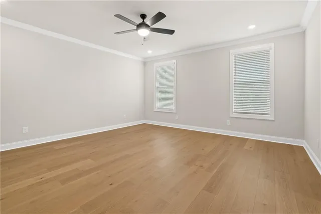 an empty room with a empty space and a ceiling fan