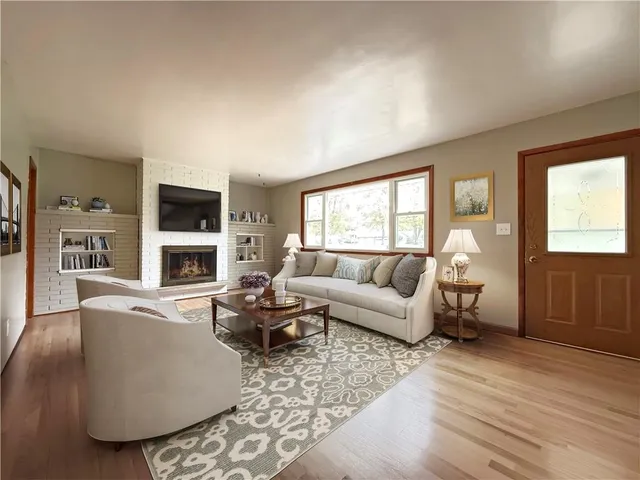 an empty room with wooden floor and fireplace