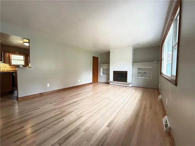 wooden floor in an empty room with a window