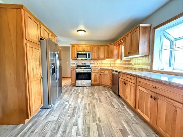 a view of a kitchen from a hallway