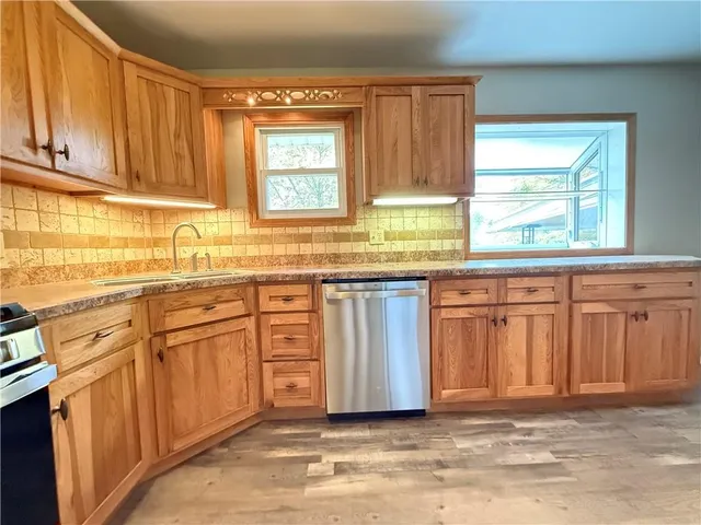 a view of a refrigerator in kitchen and wooden floor