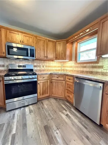 a bathroom with a tub a sink and mirror