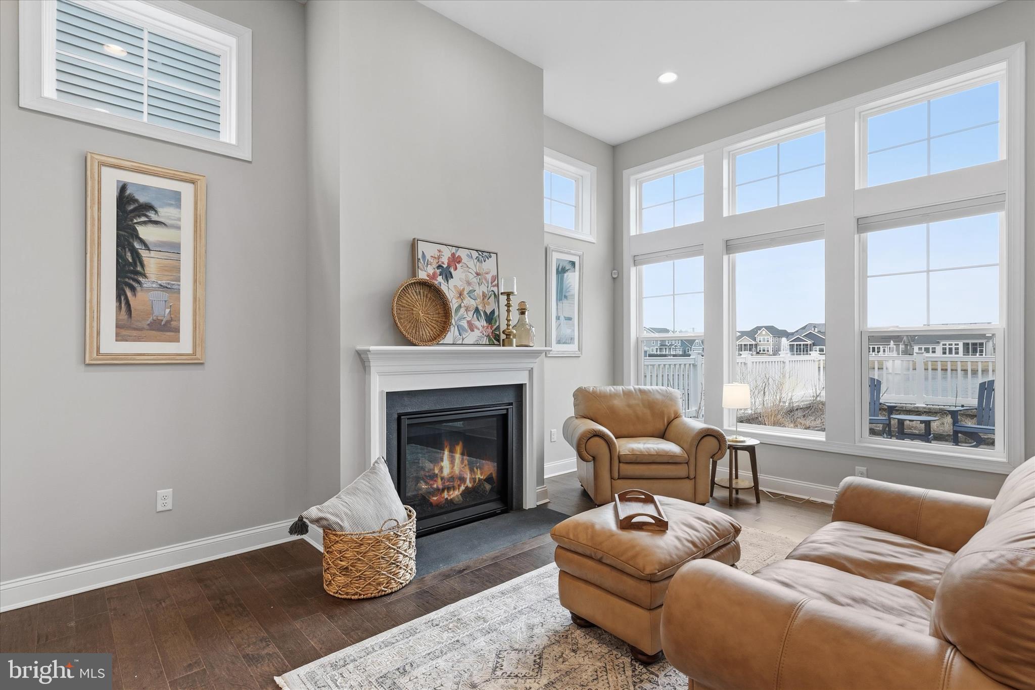 30475 Madeira Lane Ocean View, DE 19970 - Photo 12 of 38 a living room with furniture a fireplace and a floor to ceiling window