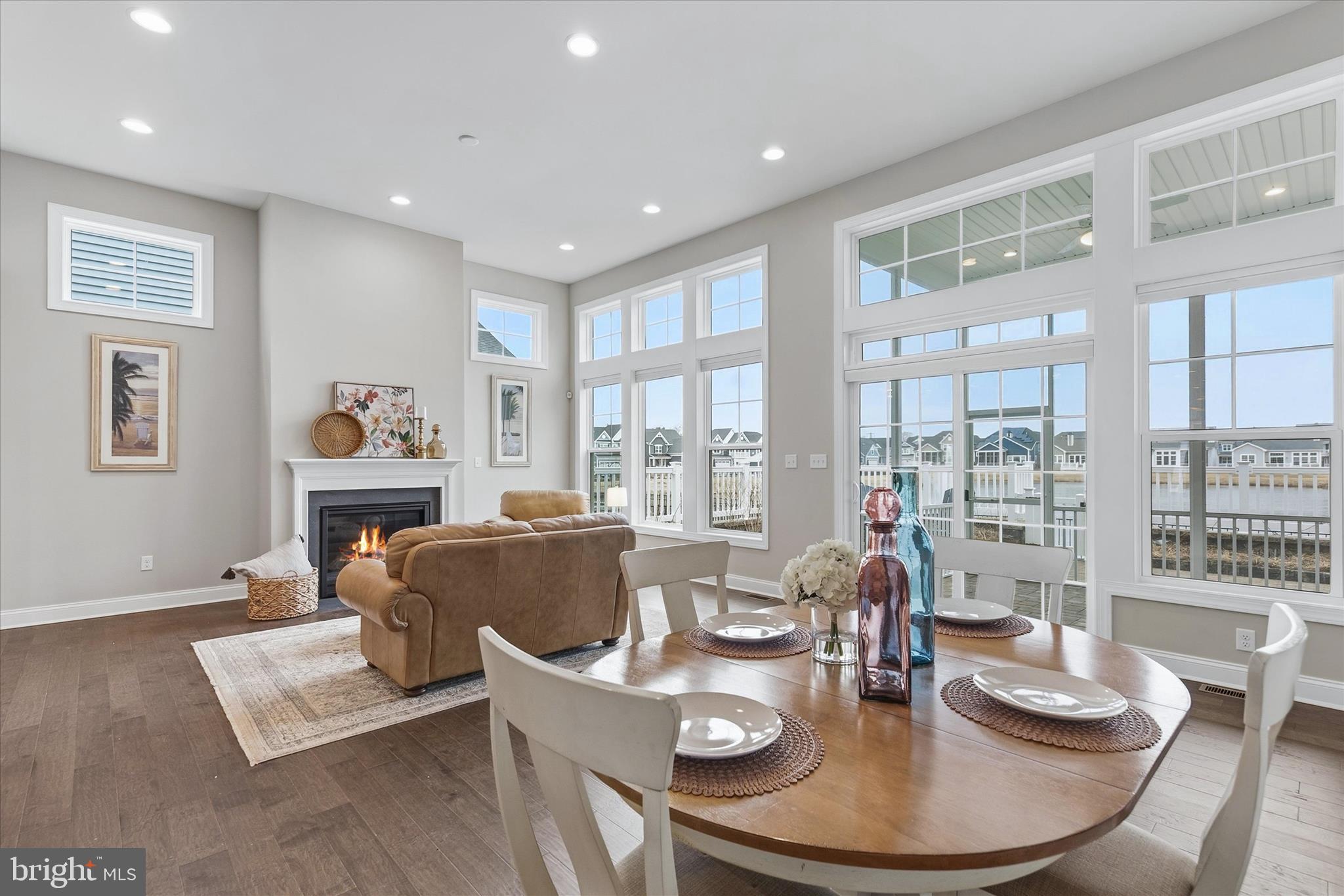 30475 Madeira Lane Ocean View, DE 19970 - Photo 13 of 38 a dining room with furniture a rug a fireplace and wooden floor