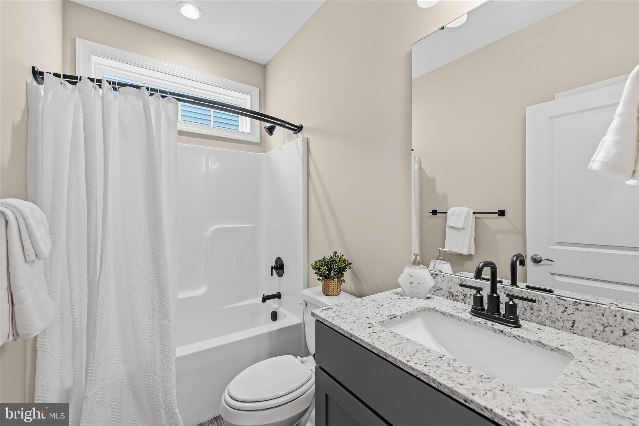30475 Madeira Lane Ocean View, DE 19970 - Photo 24 of 38 a bathroom with a granite countertop sink toilet and shower