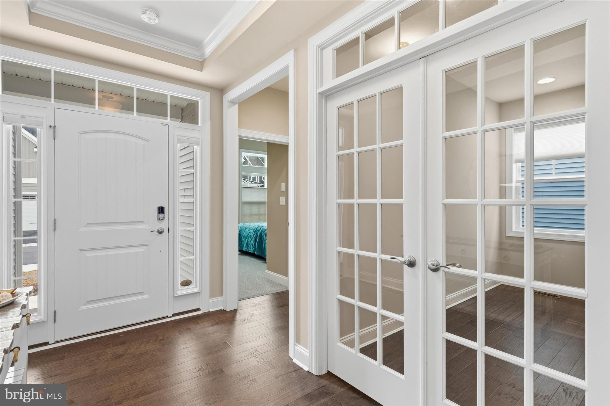 30475 Madeira Lane Ocean View, DE 19970 - Photo 4 of 38 a view of an empty room with wooden floor and windows