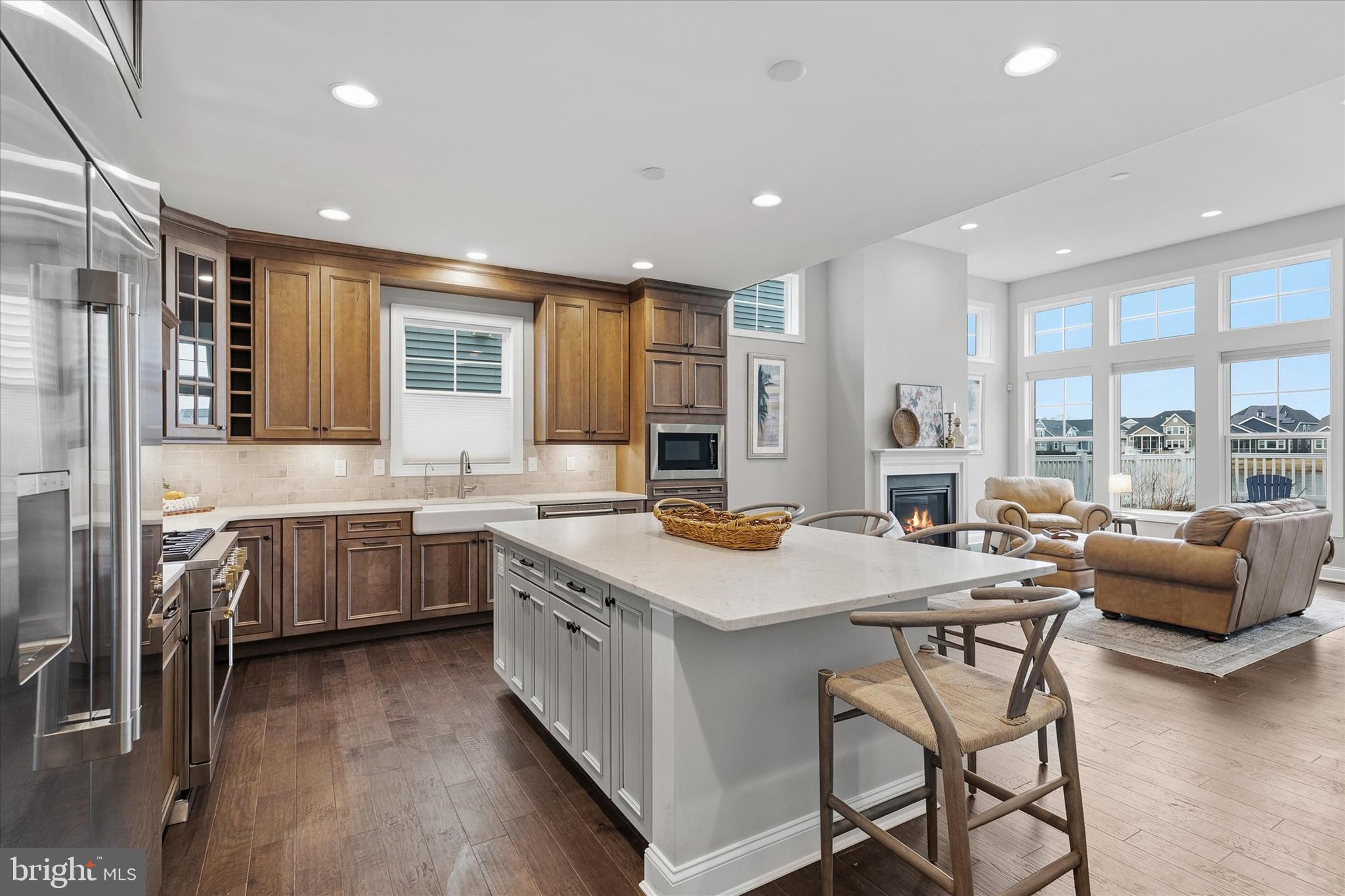 30475 Madeira Lane Ocean View, DE 19970 - Photo 8 of 38 a kitchen with stainless steel appliances kitchen island granite countertop a stove a sink a dining table and chairs