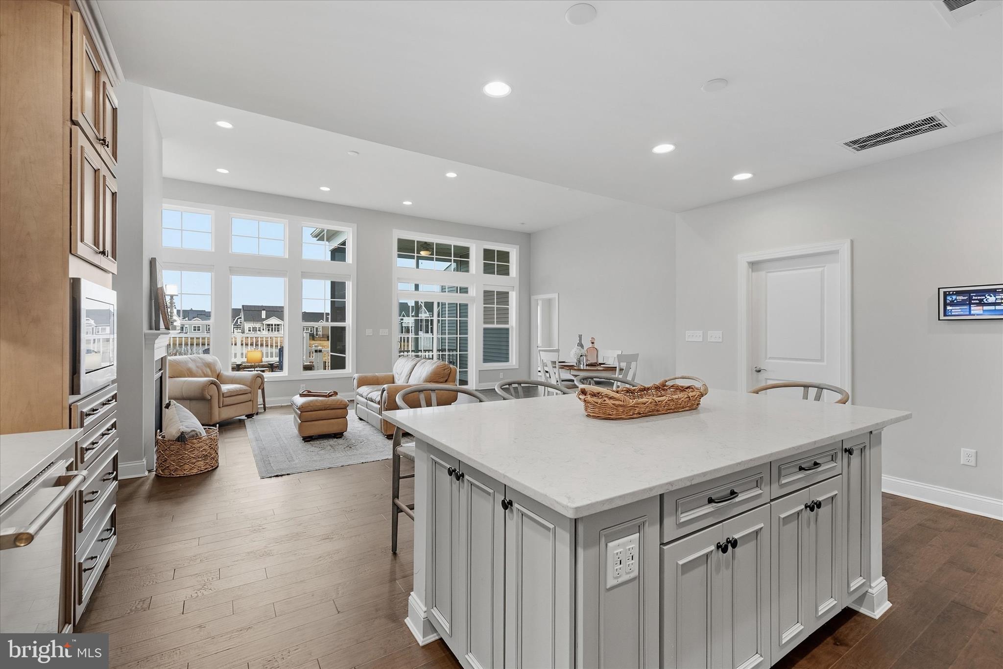 30475 Madeira Lane Ocean View, DE 19970 - Photo 10 of 38 a view of kitchen island a sink wooden floor and living room
