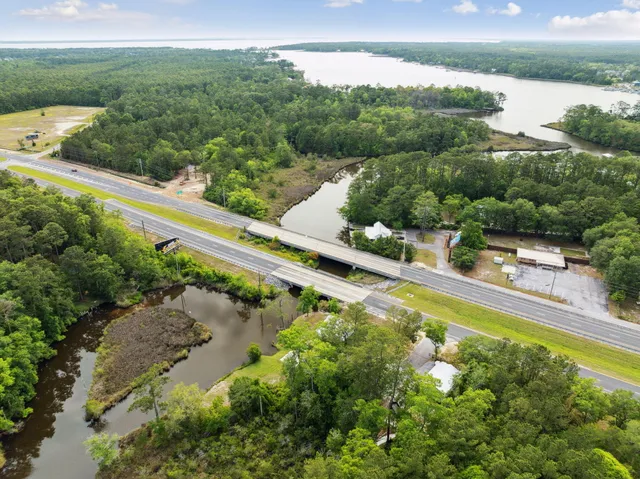 an aerial view of a house with a yard and lake view