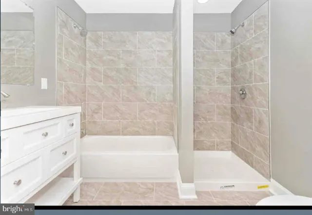 a bathroom with a bathtub and shower