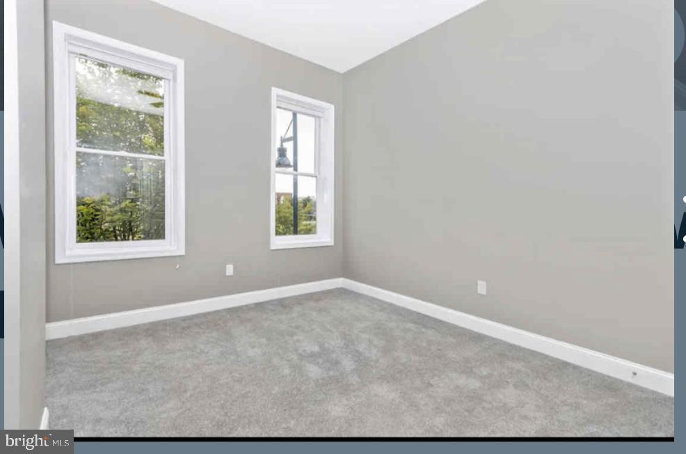 1112 Rutland Avenue Baltimore, MD 21213 - Photo 13 of 22 an empty room with windows