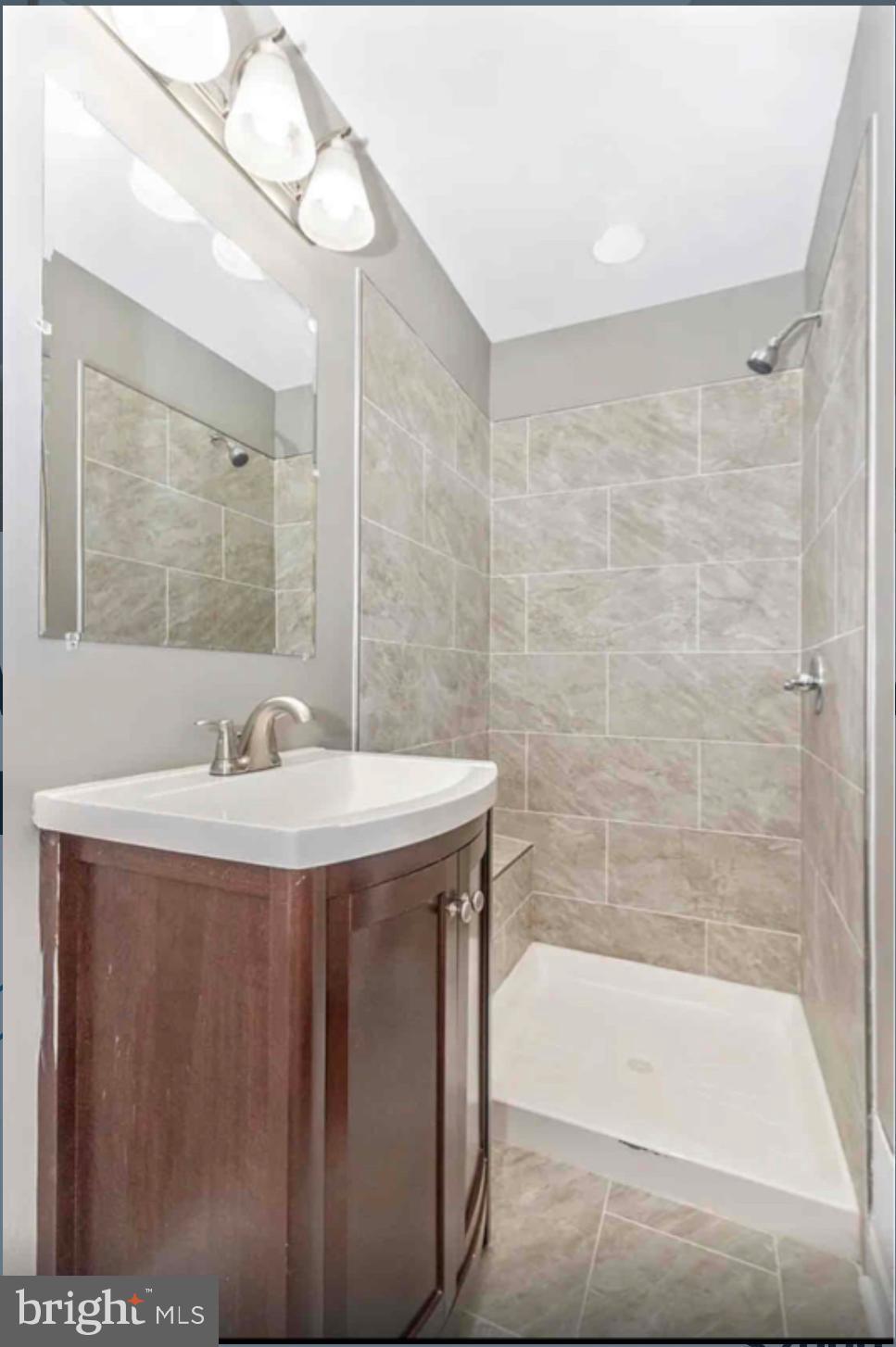 1112 Rutland Avenue Baltimore, MD 21213 - Photo 15 of 22 a bathroom with a sink and a bathtub