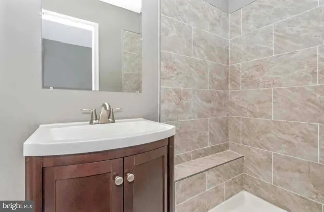 a bathroom with a sink a toilet and a mirror