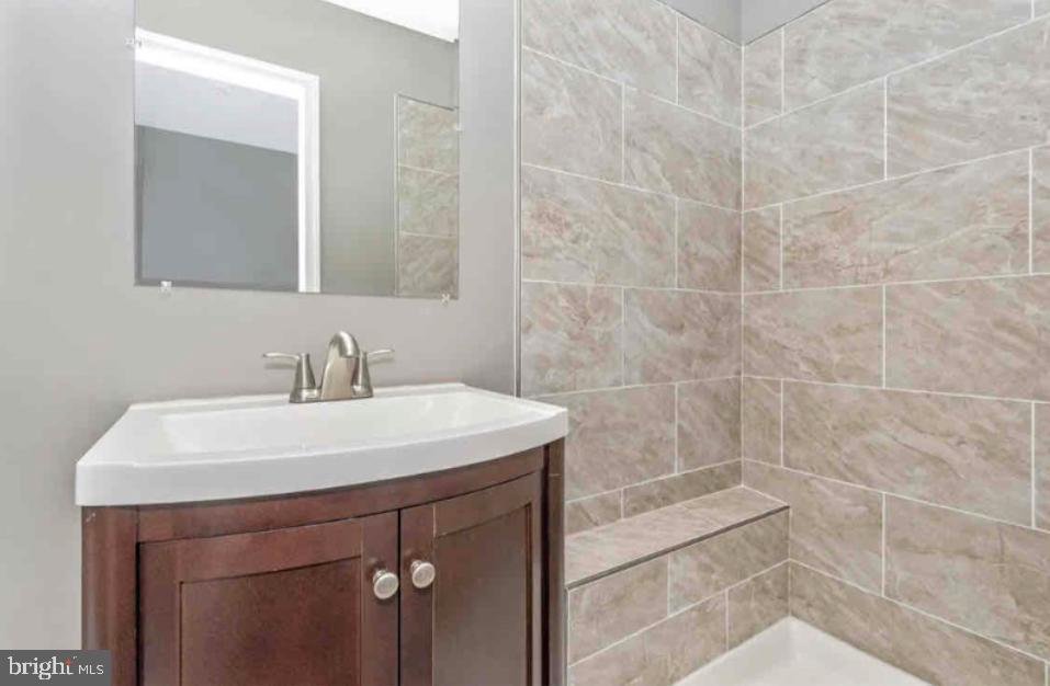 1112 Rutland Avenue Baltimore, MD 21213 - Photo 16 of 22 a bathroom with a sink a toilet and a mirror