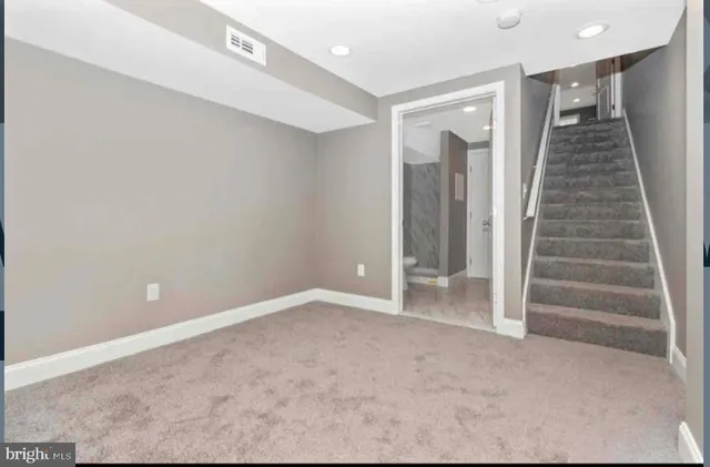 a view of an empty room with stairs
