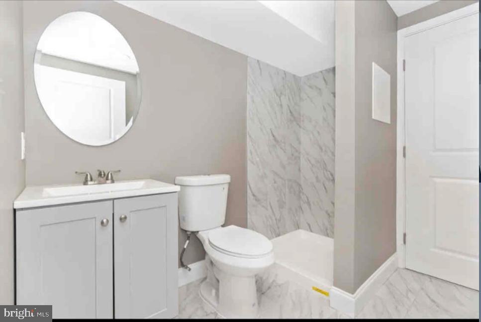 1112 Rutland Avenue Baltimore, MD 21213 - Photo 21 of 22 a bathroom with a sink toilet and shower