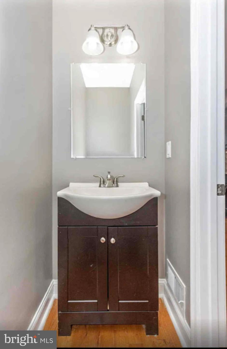 1112 Rutland Avenue Baltimore, MD 21213 - Photo 6 of 22 a bathroom with a sink and a mirror
