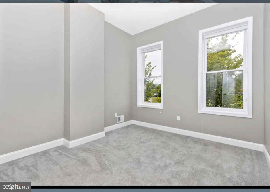 1112 Rutland Avenue Baltimore, MD 21213 - Photo 8 of 22 an empty room with windows