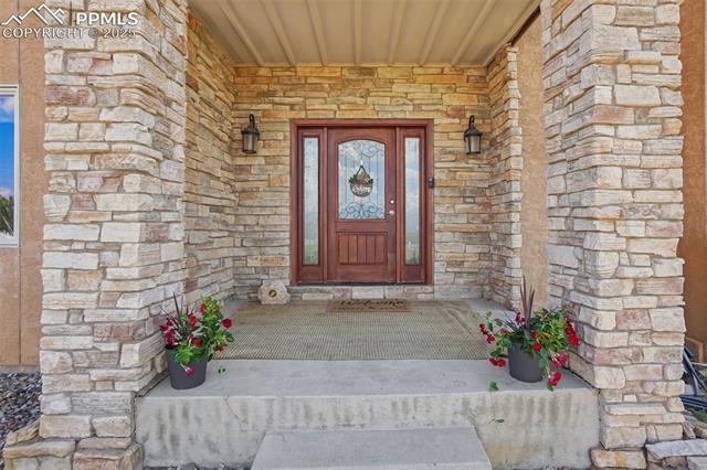 14425 Granby Road Colorado Springs, CO 80921 - Photo 3 of 45 Entrance to property featuring stone siding