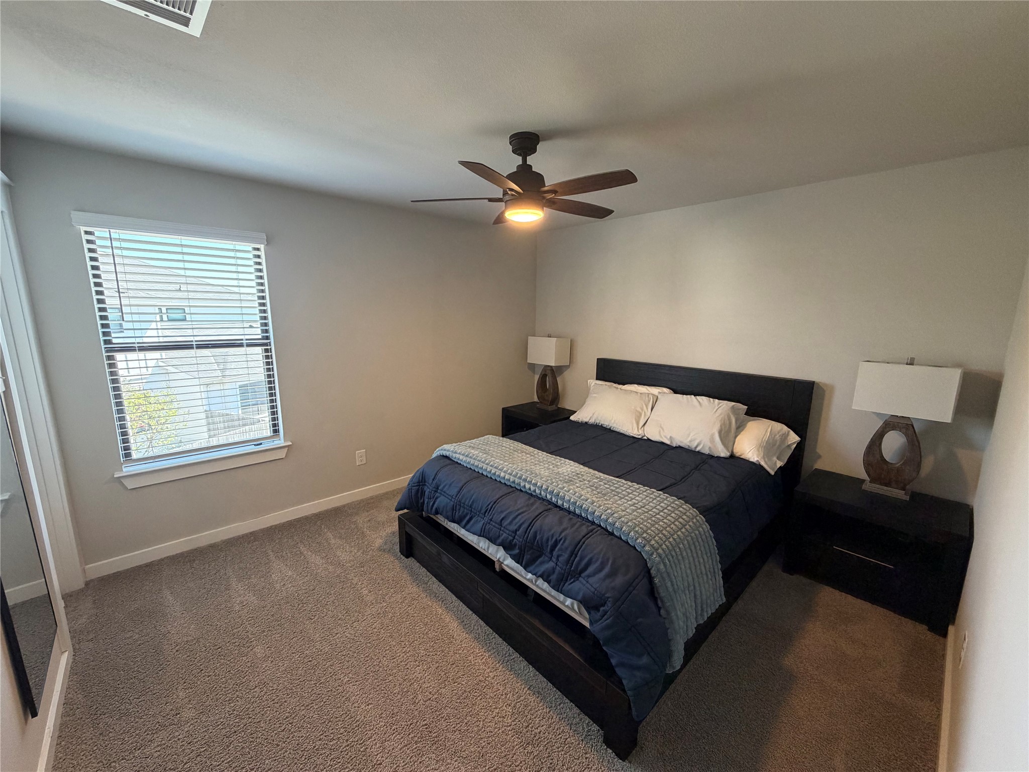 125 Threshing Road, Unit A Buda, TX 78610 - Photo 11 of 23 Bedroom featuring ceiling fan and carpet